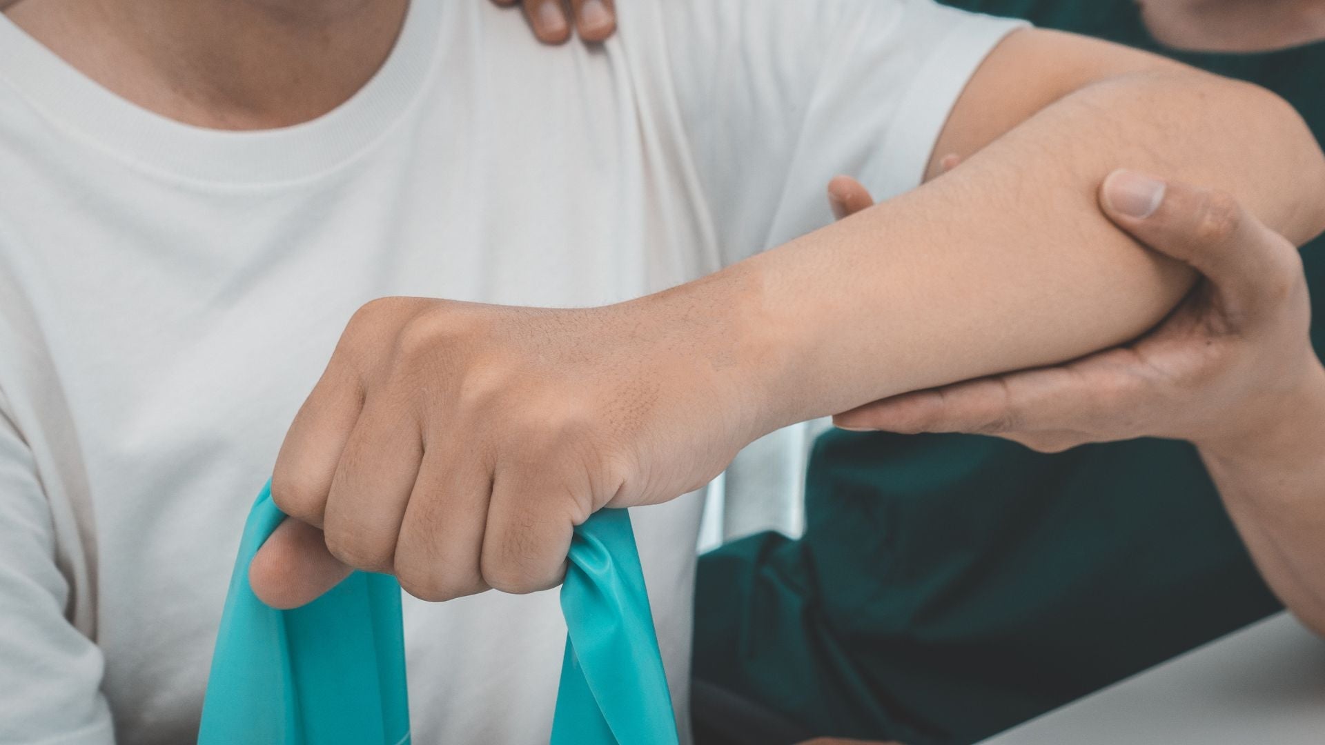man elbow being working on by a PT
