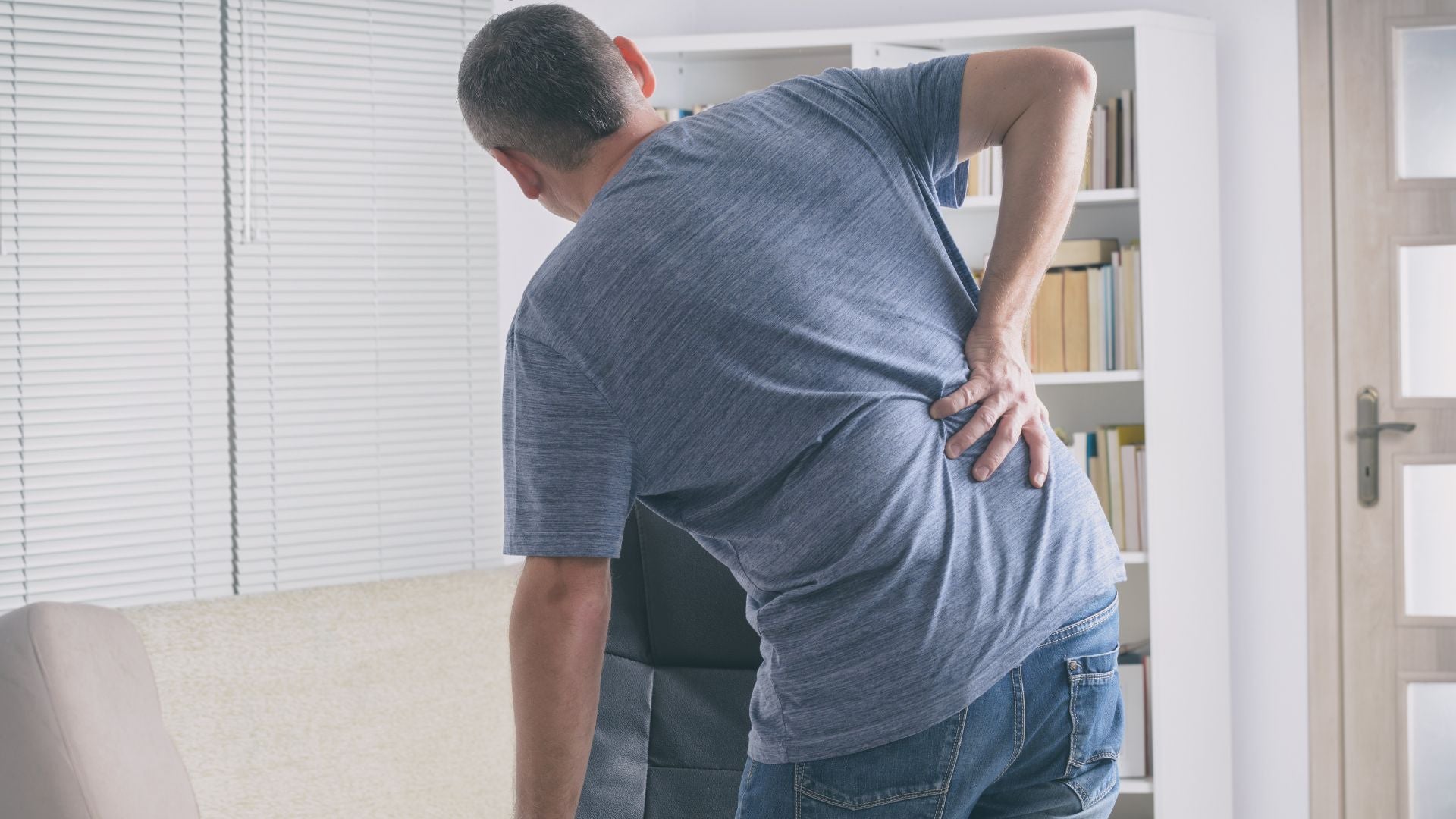 man holding his back